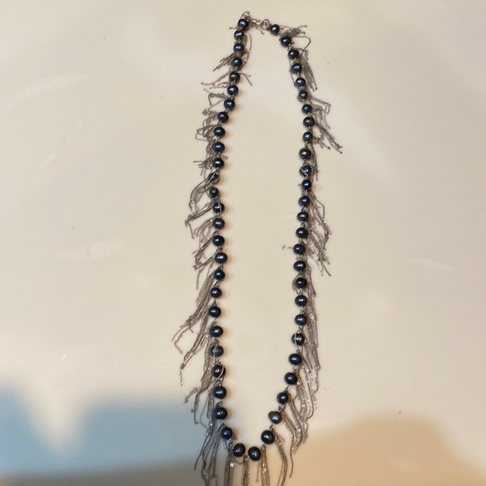 Black pearl necklace with silver fringe. Measures 15”.